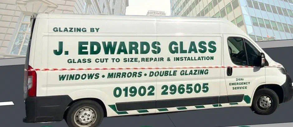 A white J Edwards Glass van with green sign-writing: glass cut to size, repair and installation, windows, mirrors, double glazing, 24-hour emergency service and the telephone number